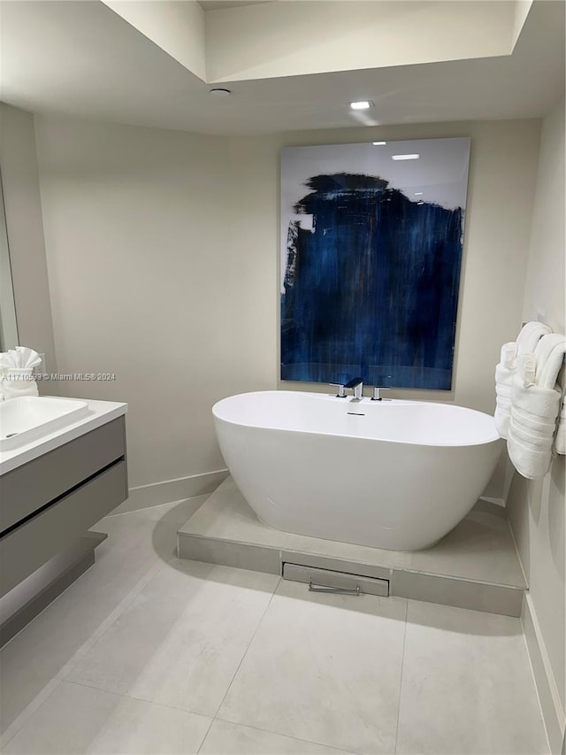 bathroom featuring a washtub, vanity, and tile patterned flooring