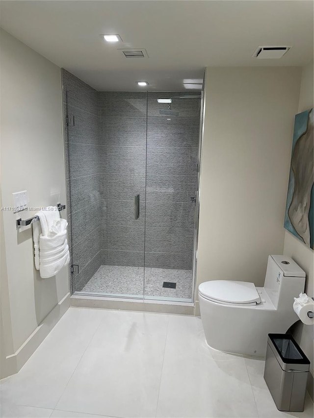 bathroom featuring tile patterned floors, toilet, and an enclosed shower