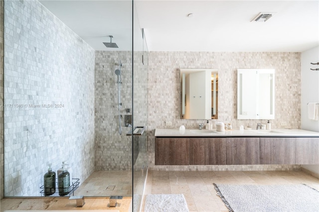 bathroom featuring vanity, a shower with door, and tile walls