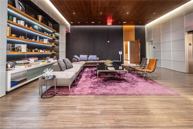 living area with light hardwood / wood-style floors and wood ceiling