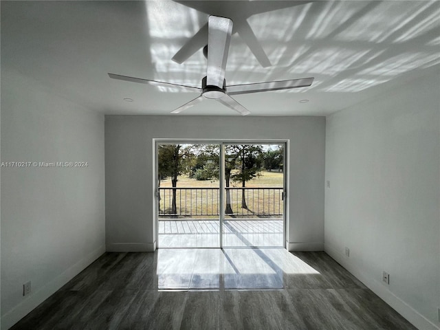 unfurnished room featuring dark hardwood / wood-style flooring and ceiling fan