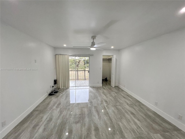 unfurnished room with ceiling fan and light wood-type flooring