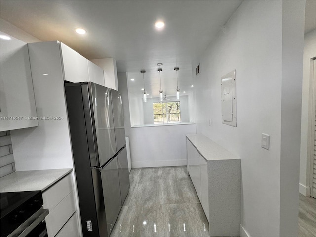 kitchen featuring hanging light fixtures, black electric range, stainless steel fridge, light hardwood / wood-style floors, and white cabinets