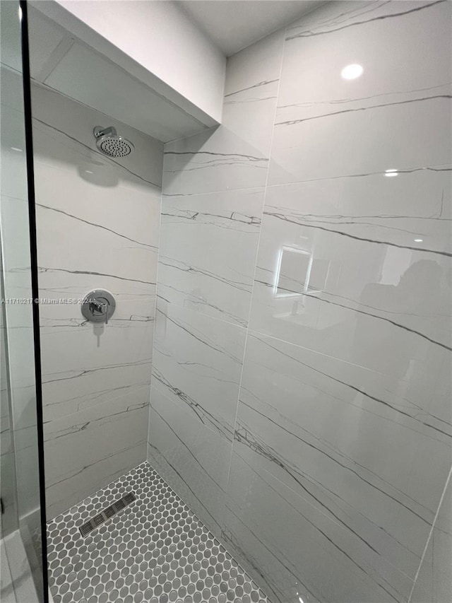 bathroom with tiled shower