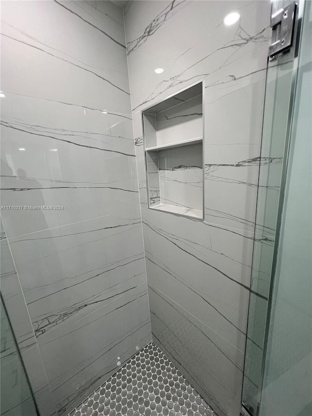 bathroom with a tile shower