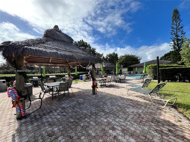 view of home's community featuring a gazebo, a pool, and a patio