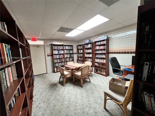 home office featuring carpet flooring and a paneled ceiling