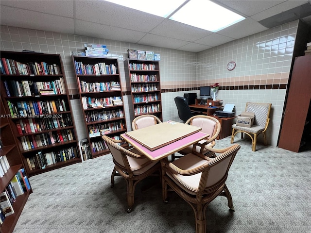 home office with carpet floors and a paneled ceiling