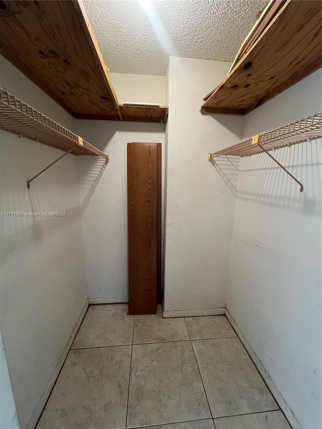 spacious closet featuring light tile patterned flooring