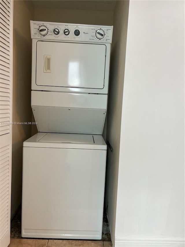 washroom with stacked washer / drying machine