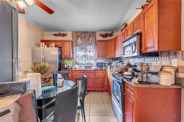 kitchen with a healthy amount of sunlight, backsplash, and appliances with stainless steel finishes