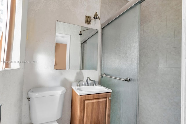 bathroom with vanity, toilet, and an enclosed shower