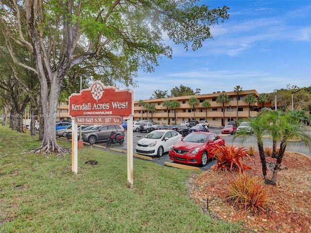 view of parking / parking lot with a lawn