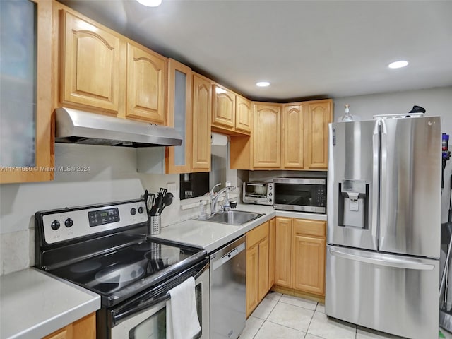 kitchen with light tile patterned flooring, light brown cabinetry, sink, and appliances with stainless steel finishes