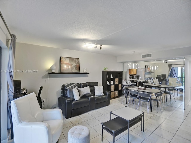 tiled living room featuring a textured ceiling