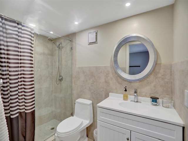 bathroom featuring a shower with shower curtain, vanity, toilet, and tile walls