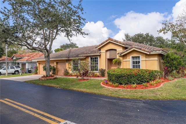 mediterranean / spanish home with a garage and a front yard