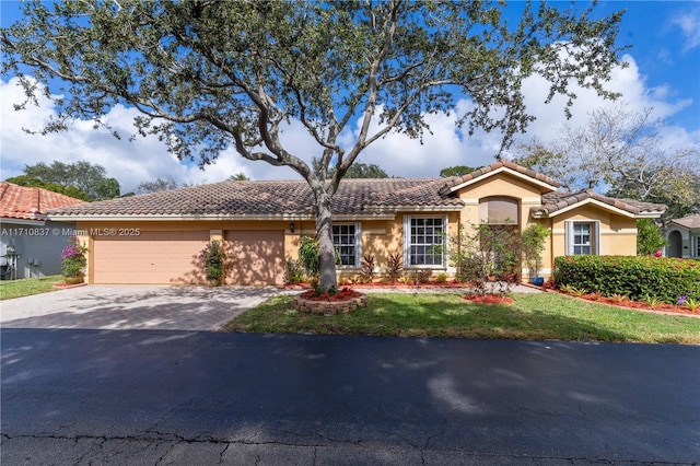 view of front of home featuring driveway, a front lawn, an attached garage, and stucco siding