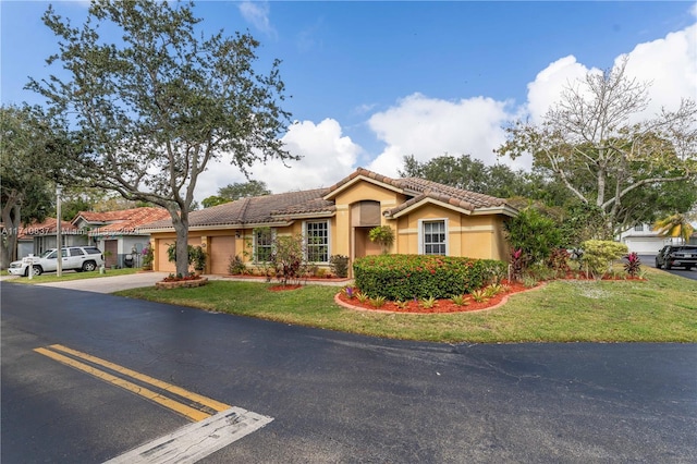 mediterranean / spanish-style house with a front yard