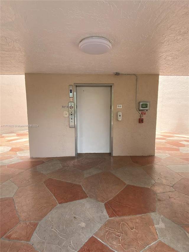 interior space with a textured ceiling