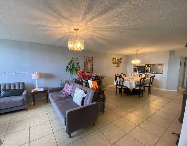 tiled living room featuring a textured ceiling and a notable chandelier