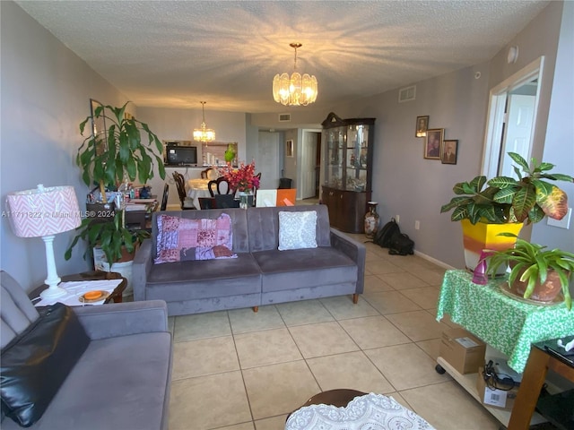 tiled living room with a notable chandelier and a textured ceiling