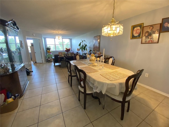 dining space featuring a chandelier and light tile patterned floors