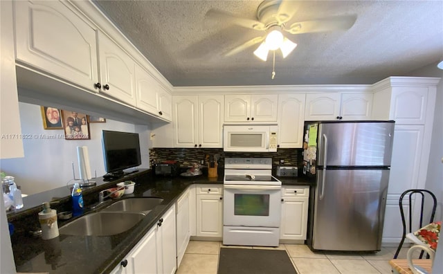 kitchen with backsplash, white appliances, sink, white cabinets, and light tile patterned flooring