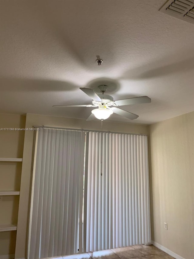 6169 Metrowest Blvd Unit 104, Orlando, FL 32835 - empty room featuring ceiling fan, a textured ceiling, and baseboards