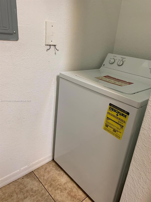 washroom featuring washer / dryer, light tile patterned floors, electric panel, baseboards, and laundry area