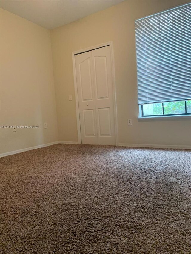 6169 Metrowest Blvd Unit 104, Orlando, FL 32835 - empty room featuring carpet and baseboards