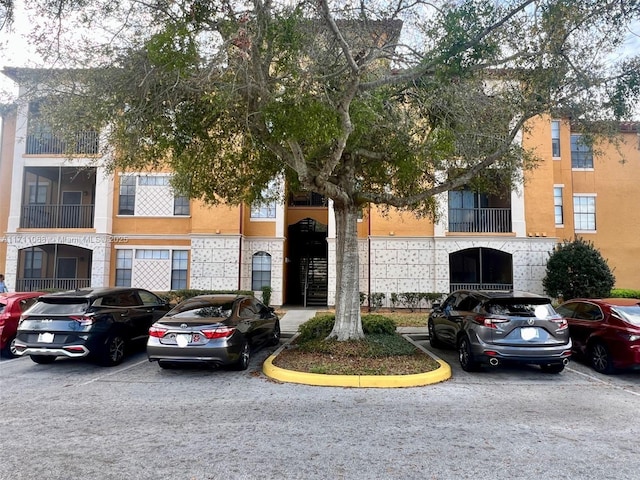 view of building exterior with uncovered parking