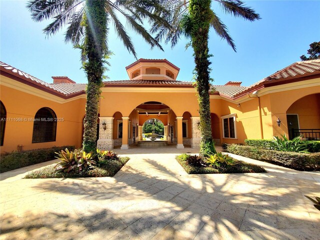 6169 Metrowest Blvd Unit 104, Orlando, FL 32835 - rear view of house featuring stucco siding and a tiled roof