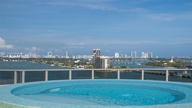 view of swimming pool featuring a water view