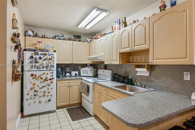 kitchen featuring white appliances, sink, a textured ceiling, light brown cabinetry, and kitchen peninsula