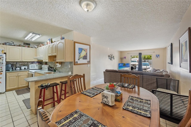 16465 NE 22nd Ave Unit 120, North Miami Beach, FL 33160 - dining area with light tile patterned floors and a textured ceiling