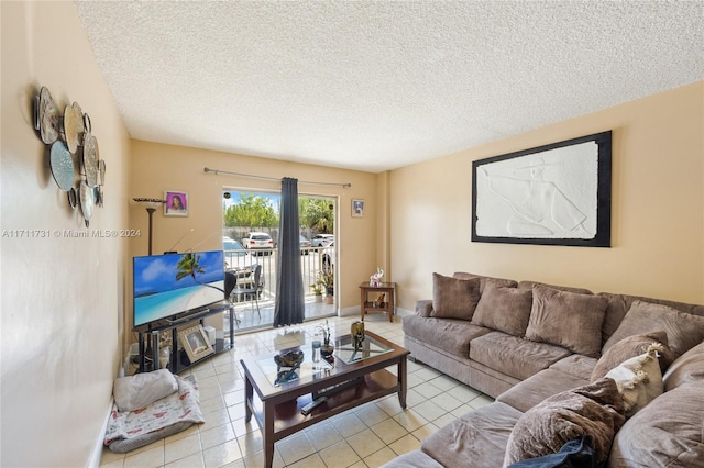 tiled living room featuring a textured ceiling