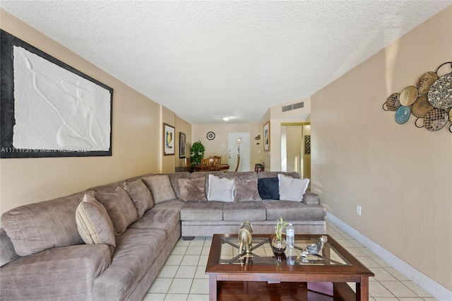 living room featuring light tile patterned floors and a textured ceiling