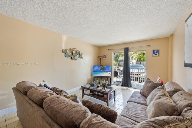 living room featuring light tile patterned floors and a textured ceiling