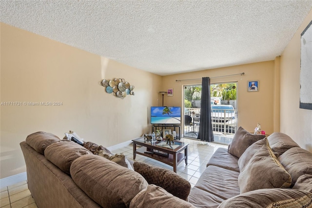 16465 NE 22nd Ave Unit 120, North Miami Beach, FL 33160 - living room featuring tile patterned floors and a textured ceiling