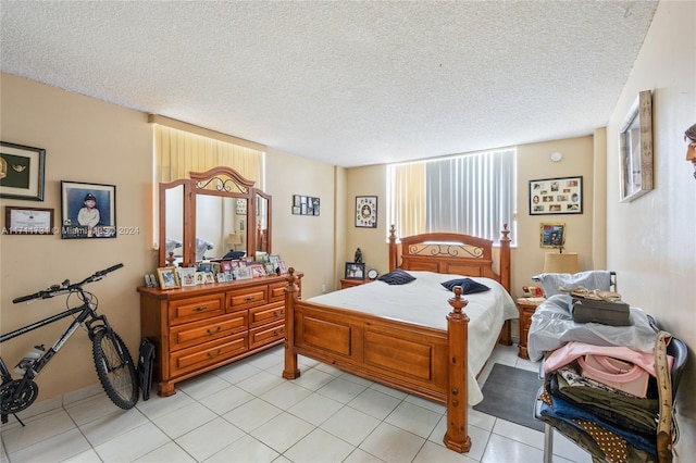 tiled bedroom featuring a textured ceiling