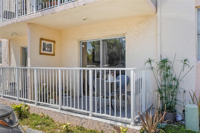 16465 NE 22nd Ave Unit 120, North Miami Beach, FL 33160 - doorway to property with stucco siding and a balcony