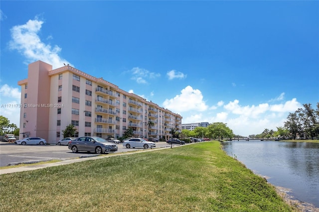 16465 NE 22nd Ave Unit 120, North Miami Beach, FL 33160 - view of apartment building / complex featuring uncovered parking and a water view
