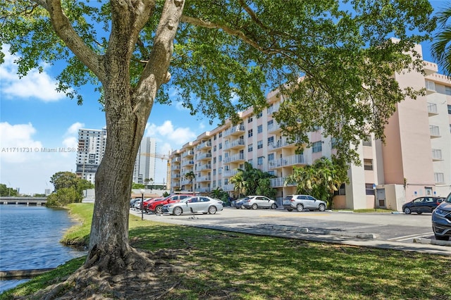 16465 NE 22nd Ave Unit 120, North Miami Beach, FL 33160 - view of apartment building / complex featuring uncovered parking and a water view