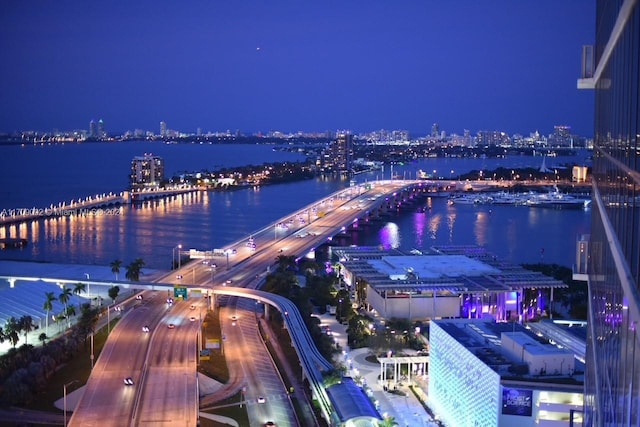 aerial view at twilight featuring a water view