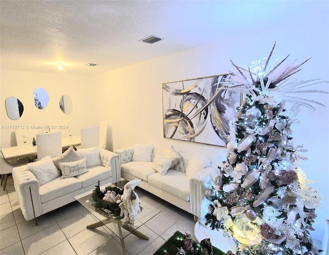 living room with tile patterned flooring and a textured ceiling