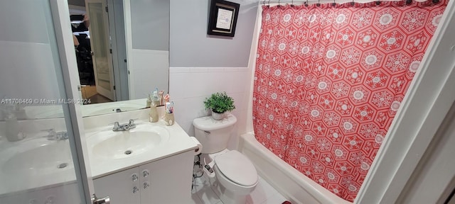 full bathroom with shower / tub combo, vanity, toilet, and tile walls