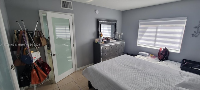 bedroom with light tile patterned floors