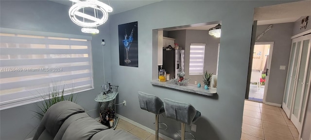 bathroom featuring tile patterned floors and a chandelier