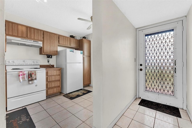 kitchen with ceiling fan, light tile patterned flooring, white appliances, and a textured ceiling